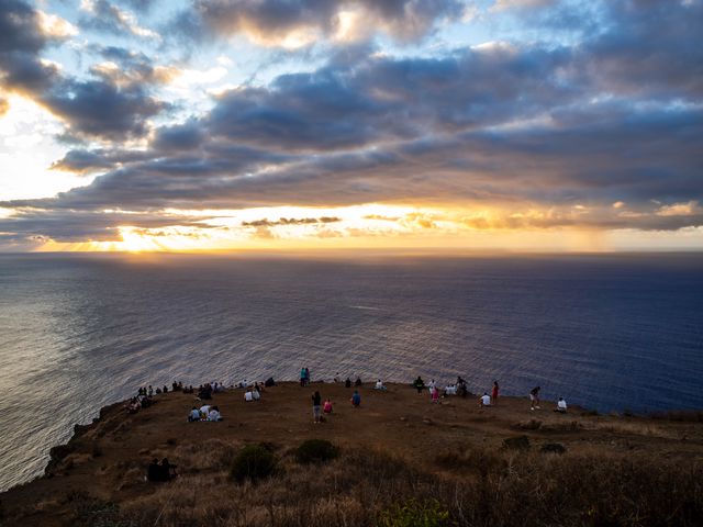 Visitors gathered on the Ponta do Pargo headland as sunset opens beneath dramatic Atlantic clouds.
