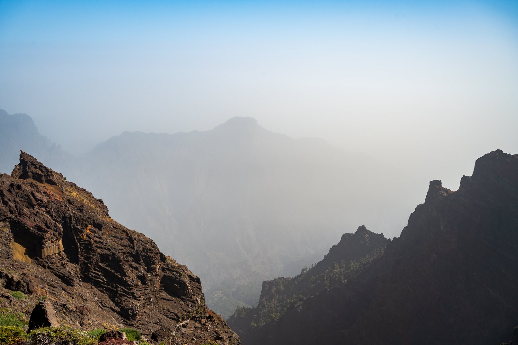 Jagged walls of the Caldera de Taburiente fading through pale mountain haze.