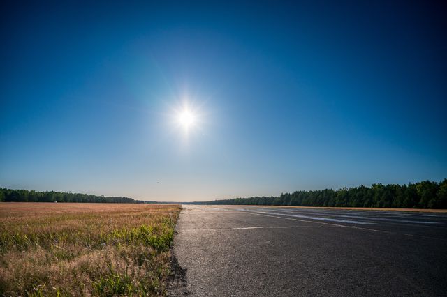 The empty Borsk runway vanishing into the distance under a high summer sun.